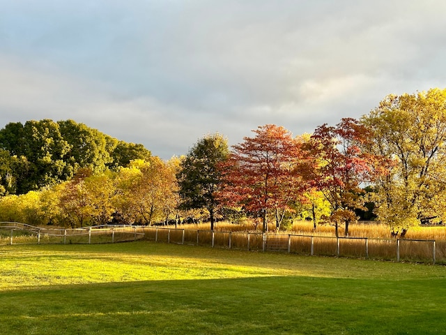 surrounding community featuring a lawn and a rural view