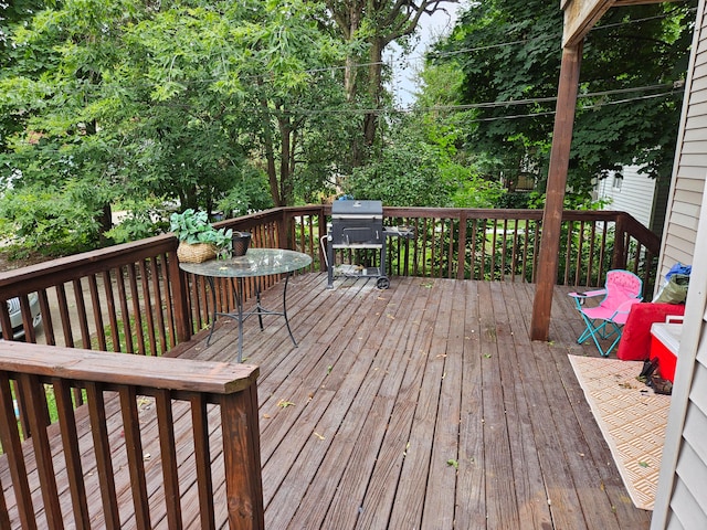 wooden terrace featuring a grill