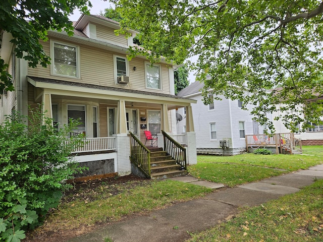 view of front of home featuring covered porch, cooling unit, and a front yard