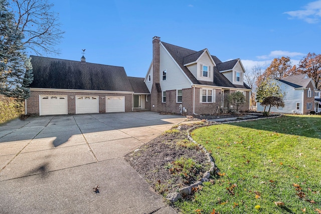 cape cod-style house with an attached garage, a chimney, concrete driveway, a front lawn, and brick siding