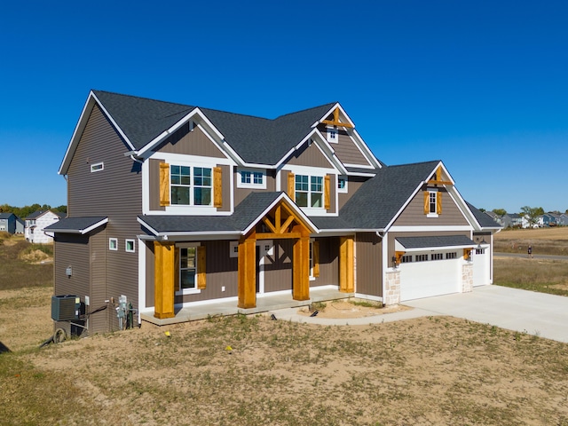 craftsman inspired home featuring central AC, covered porch, and a garage