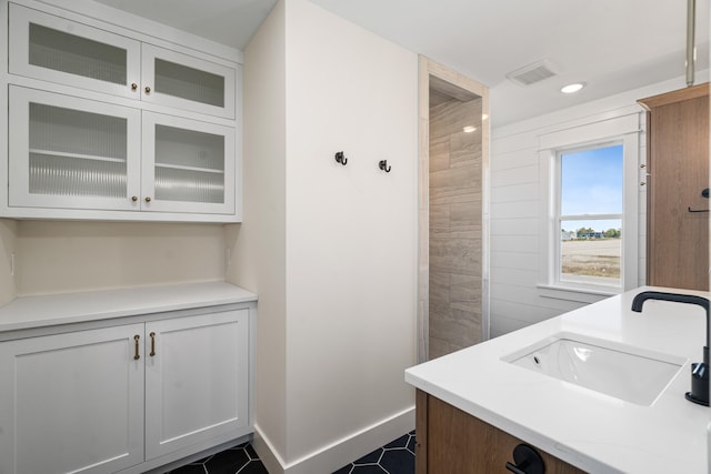 bathroom featuring tile patterned flooring and vanity