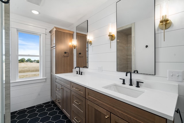 bathroom with wood walls, tile patterned flooring, and vanity