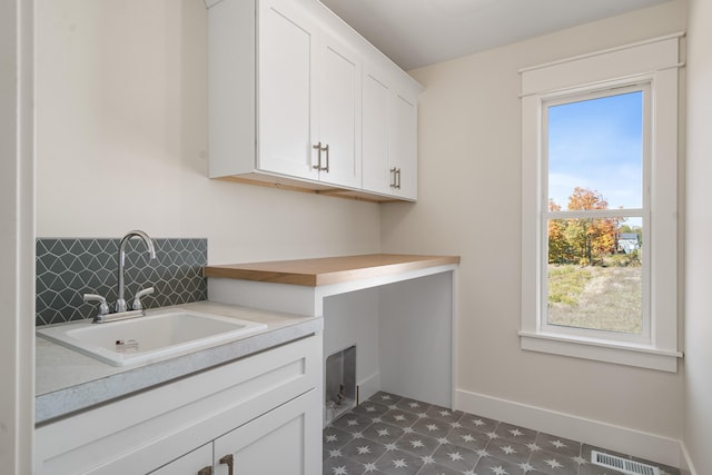 washroom with cabinets and sink