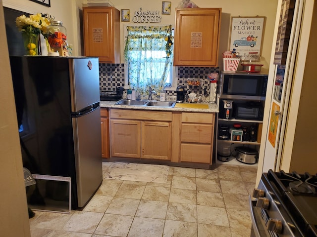 14153 Manning St, Detroit, MI 48205 - kitchen with appliances with stainless steel finishes, a sink, tasteful backsplash, light countertops, and light stone finish floors