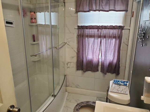 14153 Manning St, Detroit, MI 48205 - bathroom with marble look tile flooring and combined bath / shower with glass door