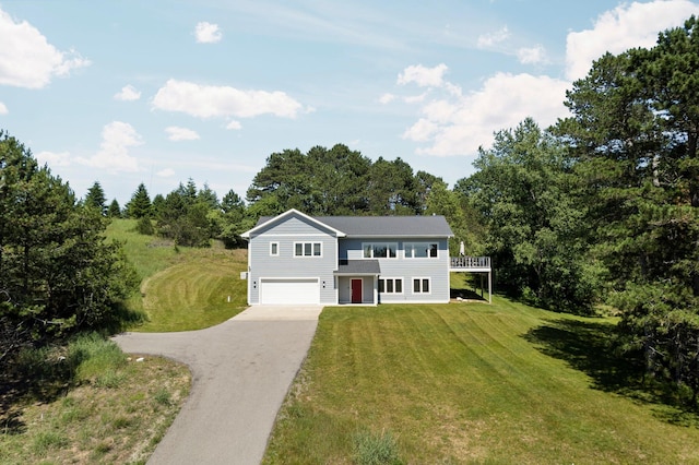 view of front of house with a garage and a front lawn