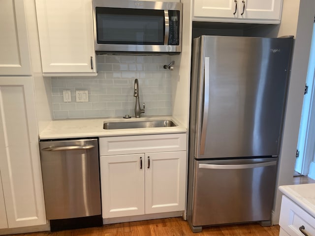 kitchen featuring white cabinets, sink, and appliances with stainless steel finishes