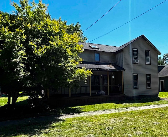 view of property exterior with a yard, cooling unit, and a sunroom