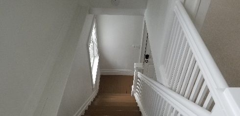 stairs with wood-type flooring