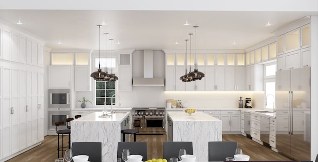 kitchen featuring a breakfast bar, premium appliances, wall chimney range hood, and an island with sink