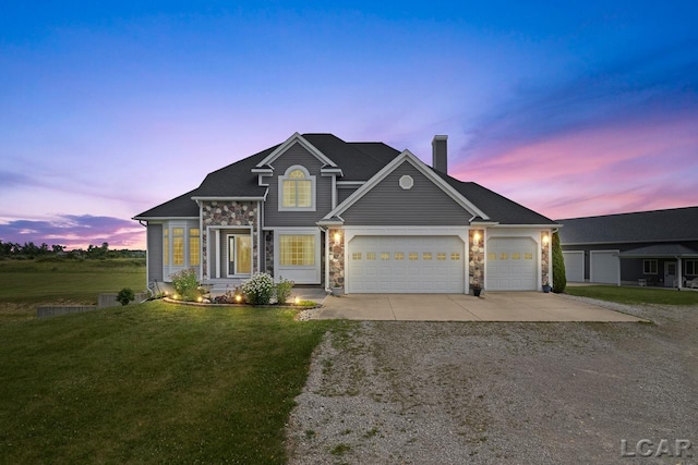 view of front of property featuring a lawn and a garage