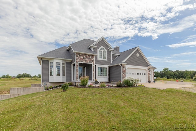 view of front facade featuring a front yard and a garage