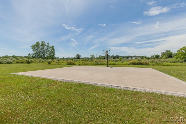 view of basketball court featuring a lawn