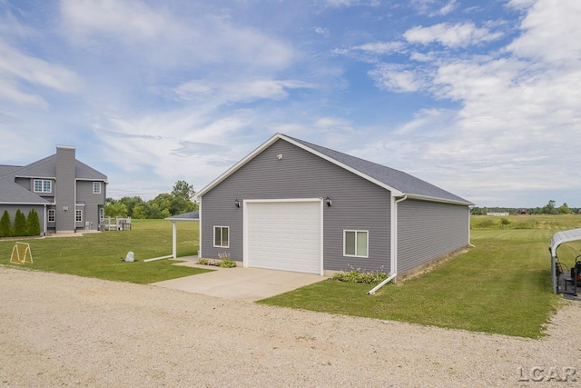 view of side of home with a yard, an outbuilding, and a garage