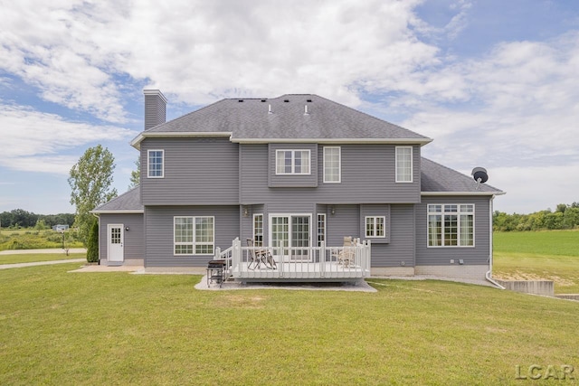 back of property featuring a yard and a deck