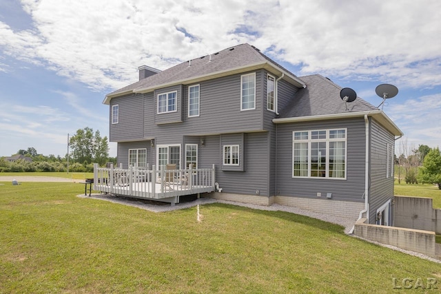 rear view of house featuring a yard and a deck