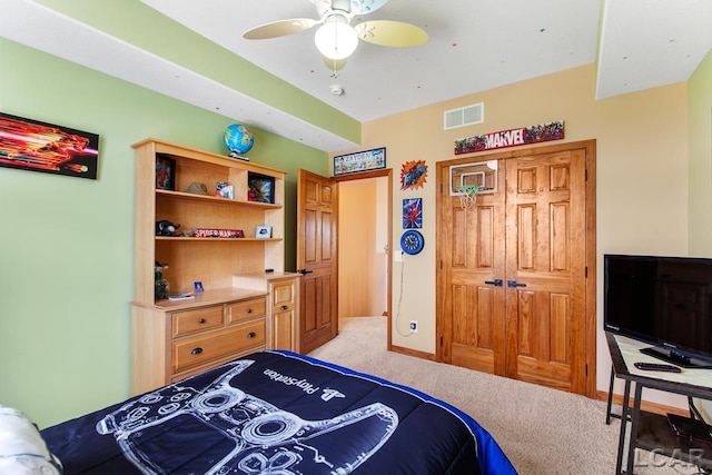 carpeted bedroom with a closet and ceiling fan