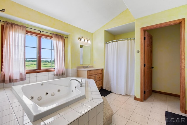 bathroom with tile patterned floors, vanity, tiled tub, and vaulted ceiling