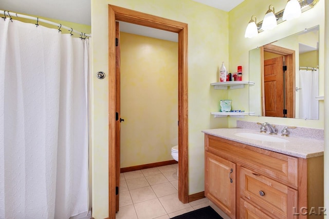 bathroom featuring tile patterned floors, vanity, and toilet