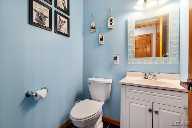 bathroom with tile patterned floors, vanity, and toilet