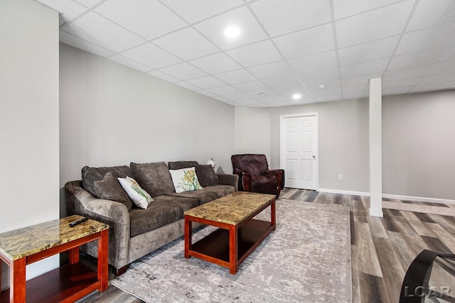 living room with a paneled ceiling and wood-type flooring