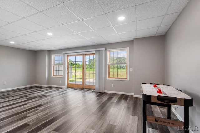 unfurnished room with a paneled ceiling and dark wood-type flooring