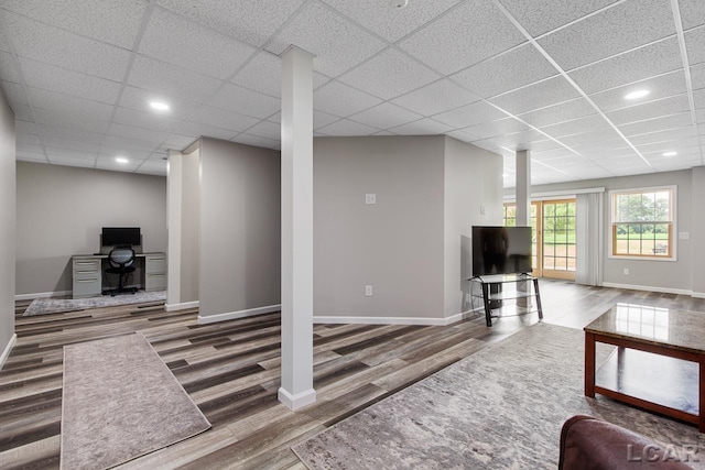 living room with hardwood / wood-style floors and a drop ceiling