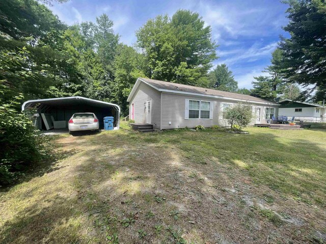 1875 Fire Rd, Twining, MI 48766 - exterior space featuring a front yard and a carport