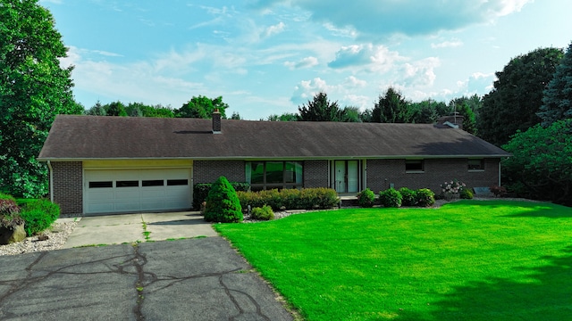 single story home with a front yard and a garage