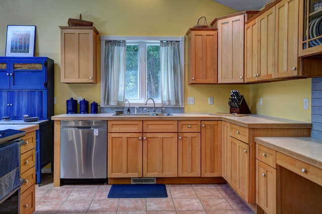 kitchen featuring stainless steel dishwasher, light tile patterned floors, and sink