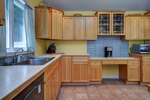 kitchen with light tile patterned floors, sink, appliances with stainless steel finishes, and tasteful backsplash