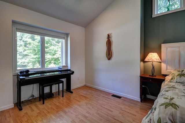 bedroom featuring vaulted ceiling and light hardwood / wood-style flooring