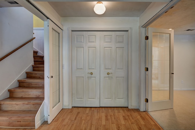 interior space with french doors and light hardwood / wood-style floors