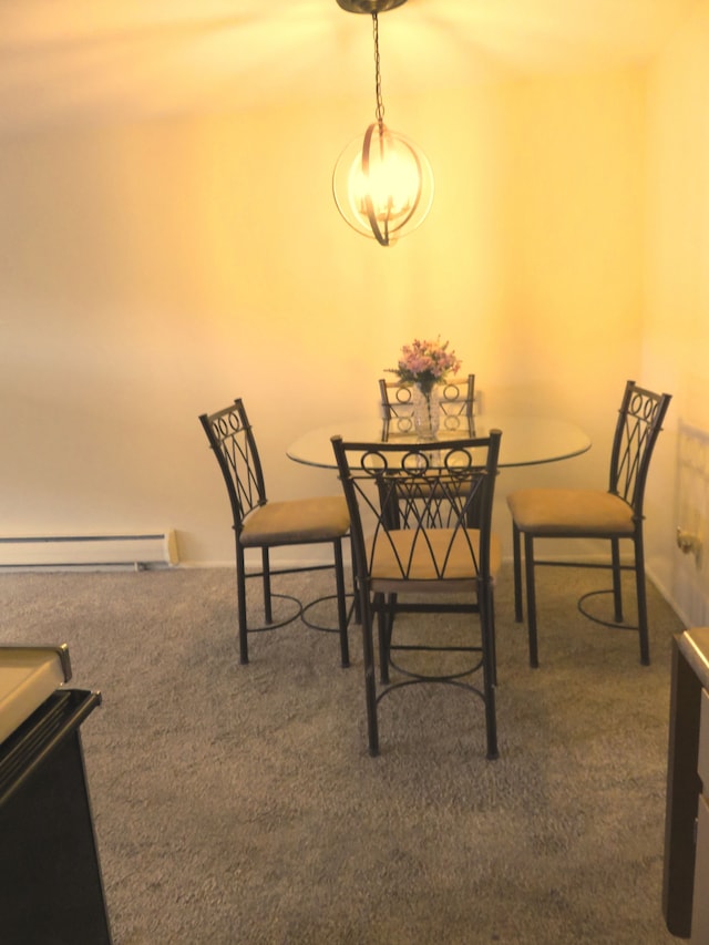 dining area featuring a baseboard radiator and carpet floors