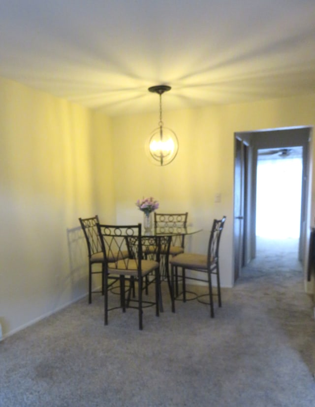 dining space featuring dark carpet