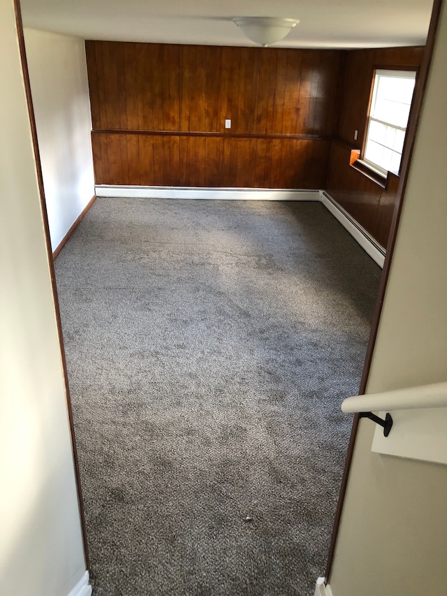 5510 Berkley Dr, Waterford, MI 48327 - carpeted spare room with a baseboard heating unit, wooden walls, and baseboards