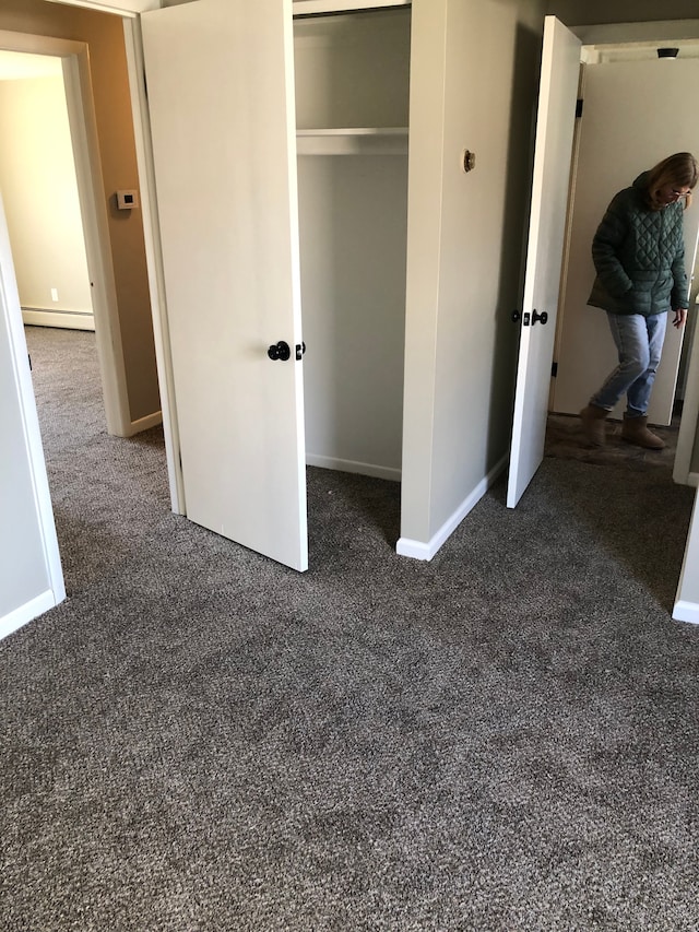 5510 Berkley Dr, Waterford, MI 48327 - unfurnished bedroom featuring carpet flooring, a baseboard radiator, baseboards, and a closet