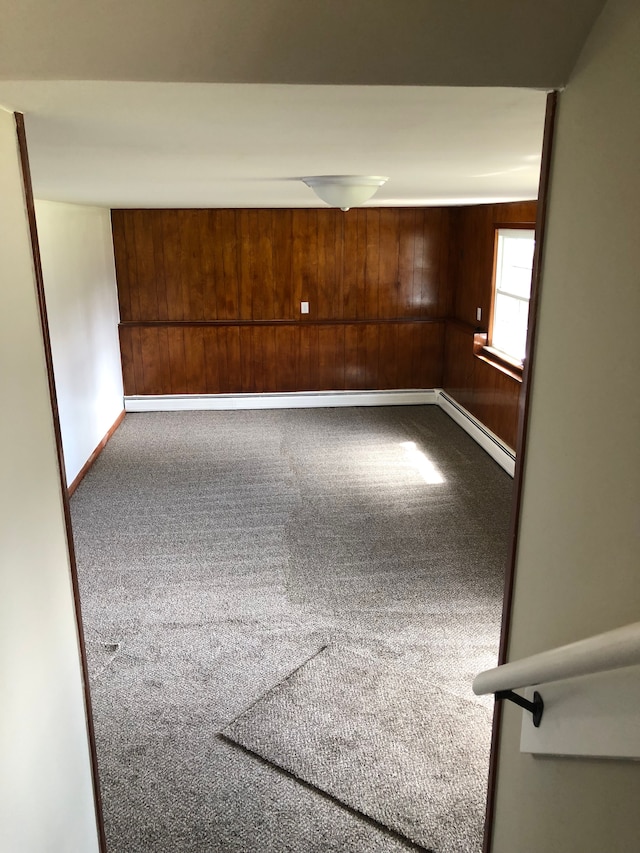 5510 Berkley Dr, Waterford, MI 48327 - empty room featuring wooden walls, carpet, baseboards, and a baseboard heating unit