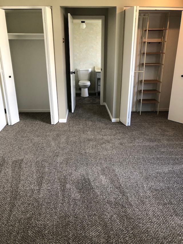 5510 Berkley Dr, Waterford, MI 48327 - unfurnished bedroom featuring carpet flooring, two closets, and baseboards