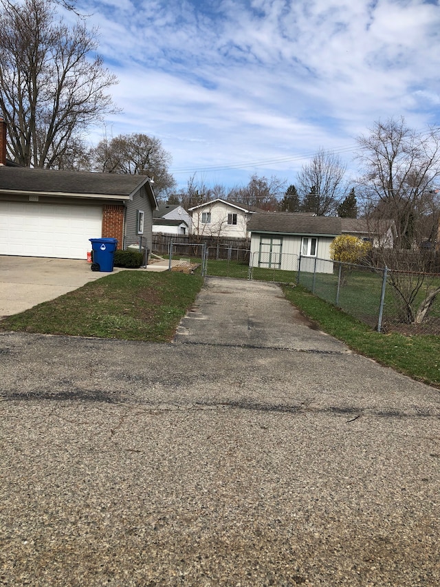 5510 Berkley Dr, Waterford, MI 48327 - view of property exterior with concrete driveway, fence, a gate, and an attached garage