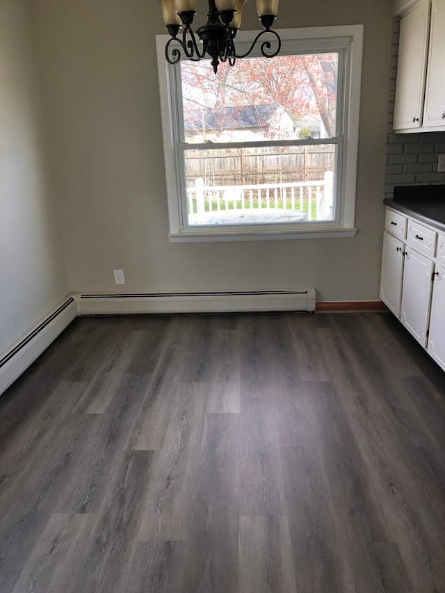 5510 Berkley Dr, Waterford, MI 48327 - unfurnished dining area with a chandelier, dark wood-style flooring, and baseboard heating