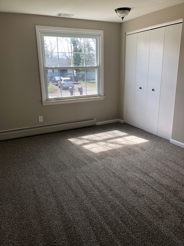 5510 Berkley Dr, Waterford, MI 48327 - unfurnished bedroom featuring carpet flooring, a closet, a baseboard radiator, and baseboards