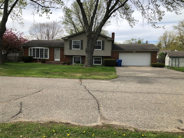 5510 Berkley Dr, Waterford, MI 48327 - split level home with brick siding, concrete driveway, a garage, and a chimney