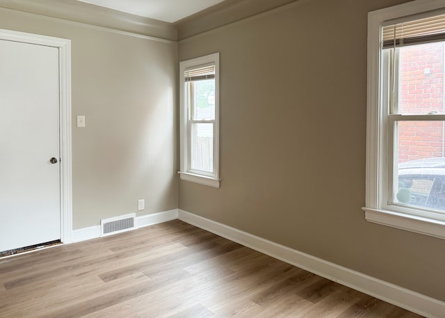 spare room with light hardwood / wood-style floors