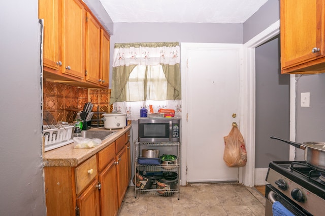 kitchen with appliances with stainless steel finishes and tasteful backsplash