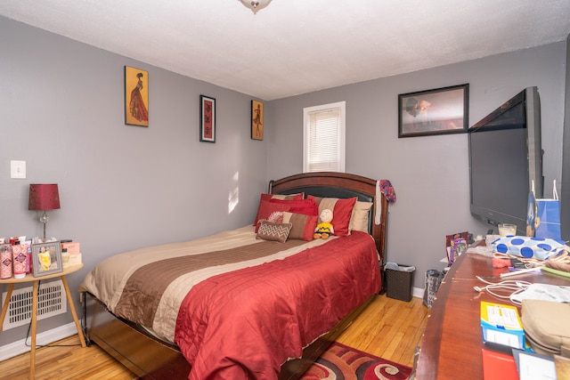 bedroom with wood-type flooring