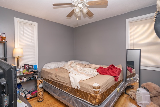 bedroom featuring hardwood / wood-style flooring and ceiling fan