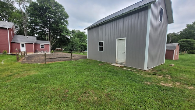 view of outbuilding featuring a yard