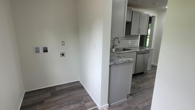 kitchen with stainless steel dishwasher, gray cabinetry, sink, and dark wood-type flooring